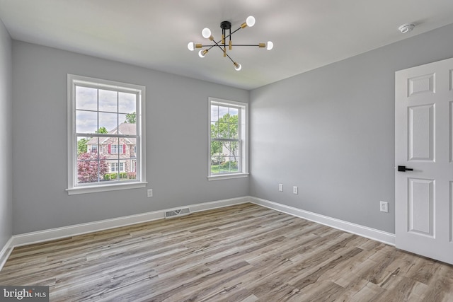 1201 Falls Grove Ln, York, PA 17404 - unfurnished room featuring a chandelier, wood finished floors, a smoke detector, and baseboards