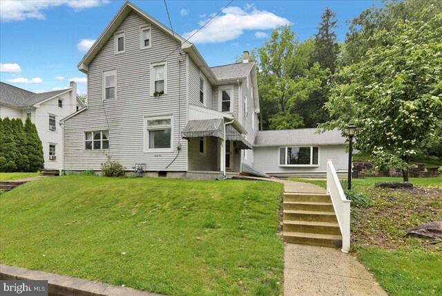 64 W Fairview St, Mohnton, PA 19540 - view of front of house featuring a front lawn and a chimney