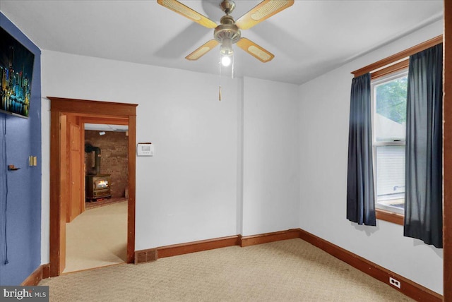 64 W Fairview St, Mohnton, PA 19540 - spare room with a wood stove, baseboards, ceiling fan, and carpet flooring