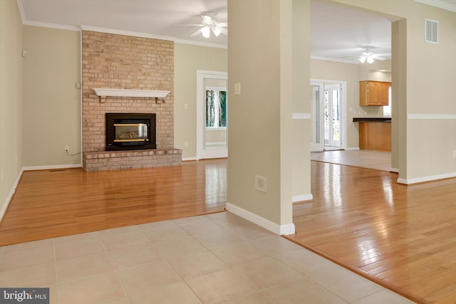 614 Cedarday Dr, Bel Air, MD 21015 - unfurnished living room with ceiling fan, light wood-type flooring, crown molding, baseboards, and a fireplace