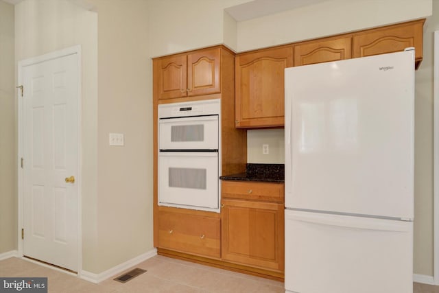 614 Cedarday Dr, Bel Air, MD 21015 - kitchen featuring white appliances, baseboards, and dark stone counters