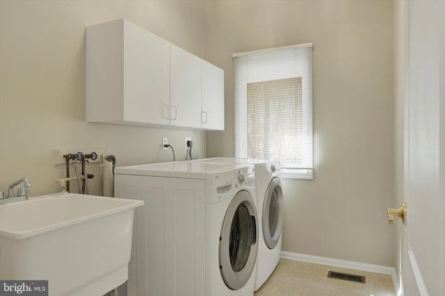 614 Cedarday Dr, Bel Air, MD 21015 - laundry area featuring cabinet space, washer and clothes dryer, light tile patterned floors, and baseboards