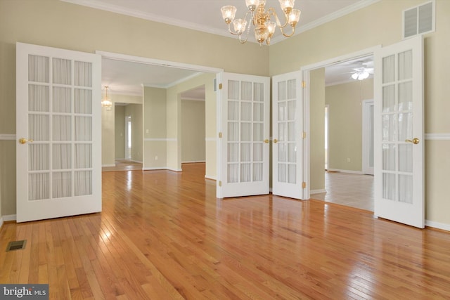 614 Cedarday Dr, Bel Air, MD 21015 - empty room featuring french doors, ornamental molding, hardwood / wood-style floors, a chandelier, and baseboards