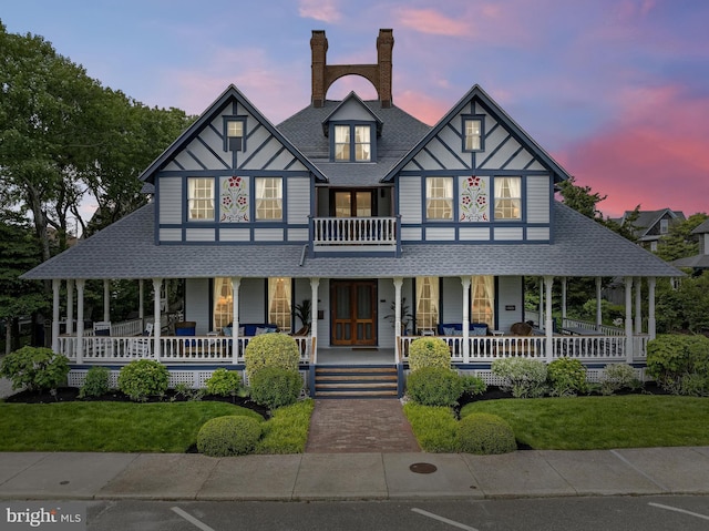 123 Coral St, Beach Haven, NJ 08008 - english style home with covered porch, a front lawn, a shingled roof, and a chimney
