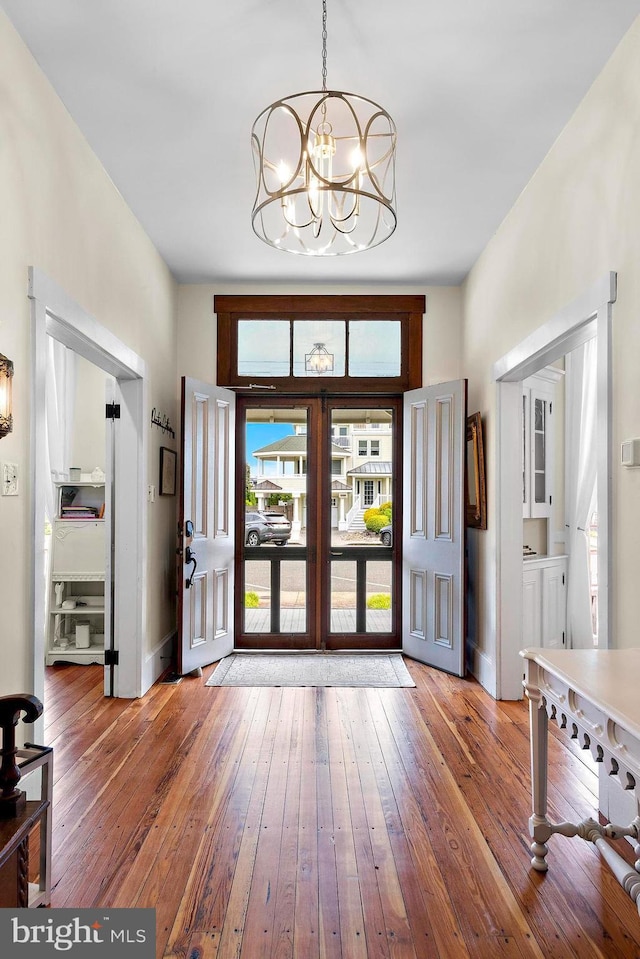 123 Coral St, Beach Haven, NJ 08008 - entryway with hardwood / wood-style flooring, a chandelier, french doors, and baseboards