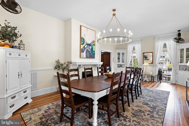 123 Coral St, Beach Haven, NJ 08008 - dining room with a chandelier, light wood finished floors, and baseboards