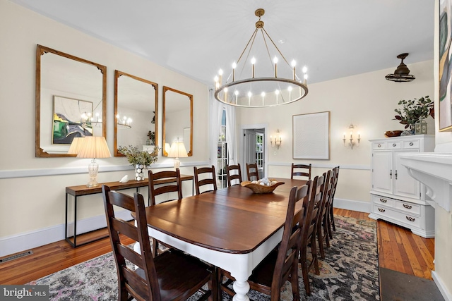 123 Coral St, Beach Haven, NJ 08008 - dining space featuring a chandelier, wood finished floors, and baseboards