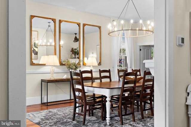 123 Coral St, Beach Haven, NJ 08008 - dining area featuring a chandelier, wood finished floors, and baseboards