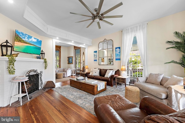 123 Coral St, Beach Haven, NJ 08008 - living area featuring ceiling fan, wood-type flooring, healthy amount of natural light, and a brick fireplace