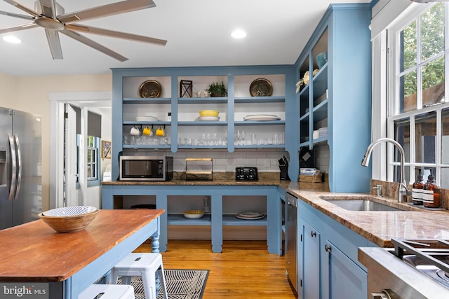 123 Coral St, Beach Haven, NJ 08008 - kitchen featuring stainless steel appliances, a sink, open shelves, blue cabinets, and recessed lighting