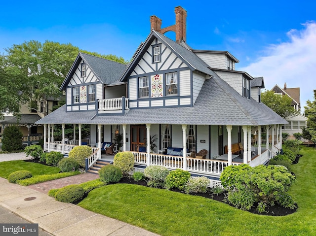 123 Coral St, Beach Haven, NJ 08008 - view of front of house with covered porch, roof with shingles, a front yard, and a chimney