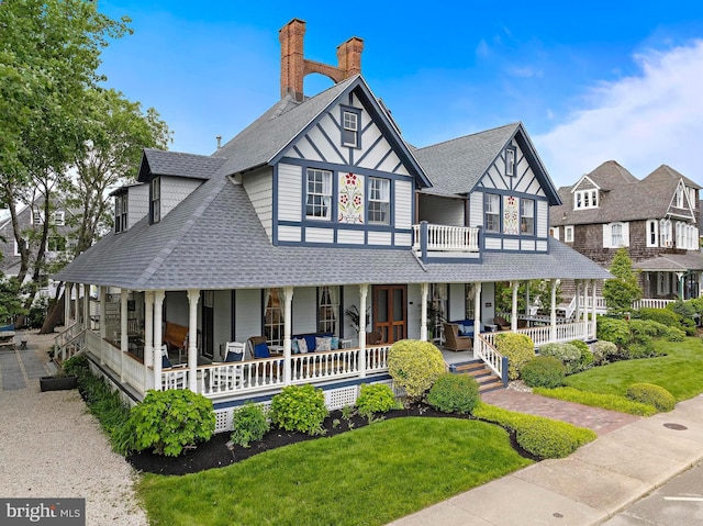 123 Coral St, Beach Haven, NJ 08008 - view of front facade featuring covered porch, roof with shingles, a front lawn, and a chimney