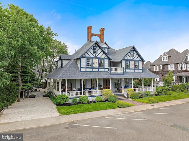 123 Coral St, Beach Haven, NJ 08008 - view of front facade with covered porch, a chimney, uncovered parking, and a shingled roof