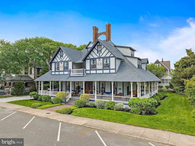 123 Coral St, Beach Haven, NJ 08008 - view of front of house featuring covered porch, a chimney, a front yard, and a shingled roof