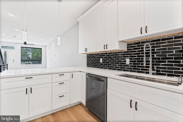 1838 N 4th St, Philadelphia, PA 19122 - kitchen with stainless steel dishwasher, light countertops, a peninsula, backsplash, and light wood finished floors