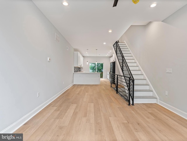 1838 N 4th St, Philadelphia, PA 19122 - unfurnished living room featuring light wood-style flooring, stairway, and recessed lighting