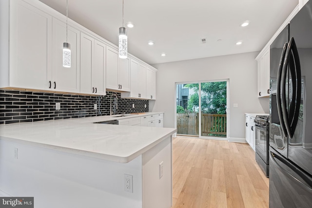 1838 N 4th St, Philadelphia, PA 19122 - kitchen featuring freestanding refrigerator, black range with gas cooktop, light countertops, white cabinetry, and light wood finished floors