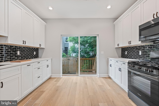 1838 N 4th St, Philadelphia, PA 19122 - kitchen featuring range with gas cooktop, stainless steel microwave, light countertops, light wood finished floors, and recessed lighting
