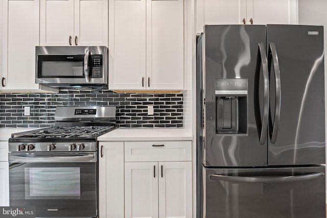 1838 N 4th St, Philadelphia, PA 19122 - kitchen with appliances with stainless steel finishes, light countertops, white cabinets, and decorative backsplash