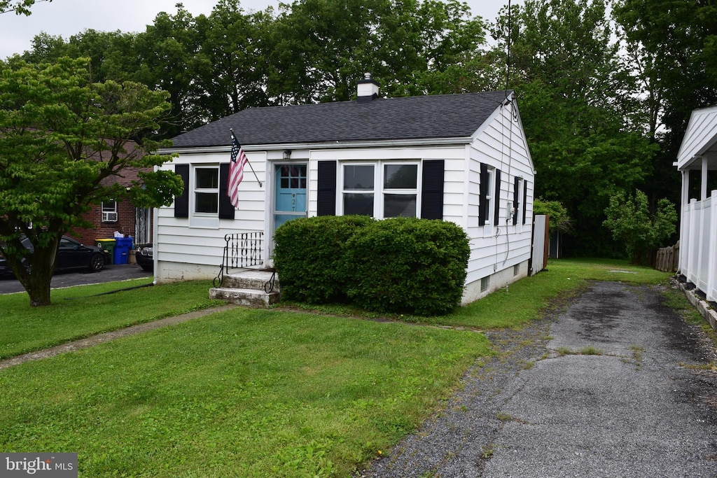 27 Plymouth Ave, Lancaster, PA 17602 - bungalow-style house with a front lawn, roof with shingles, and a chimney