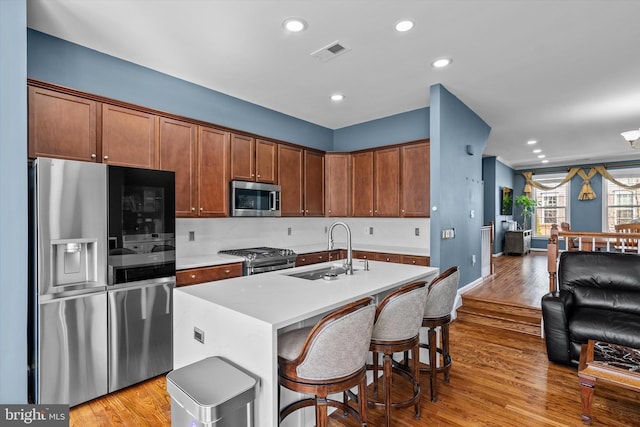 22650 Gray Falcon, Ashburn, VA 20148 - kitchen with stainless steel appliances, a sink, light wood-style floors, light countertops, and recessed lighting