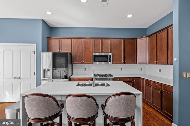 22650 Gray Falcon, Ashburn, VA 20148 - kitchen featuring appliances with stainless steel finishes, a sink, dark wood-style floors, light countertops, and recessed lighting