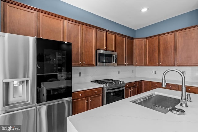 22650 Gray Falcon, Ashburn, VA 20148 - kitchen featuring appliances with stainless steel finishes, a sink, light stone counters, backsplash, and recessed lighting