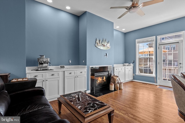 22650 Gray Falcon, Ashburn, VA 20148 - living room with a ceiling fan, a fireplace with flush hearth, wood finished floors, and recessed lighting