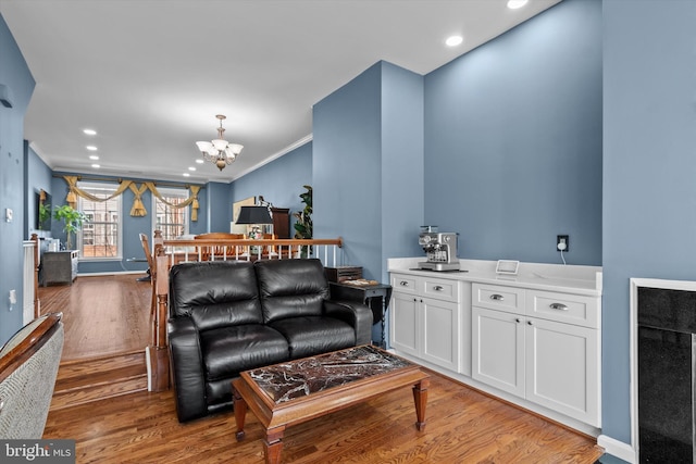 22650 Gray Falcon, Ashburn, VA 20148 - living area with wood finished floors, a chandelier, ornamental molding, recessed lighting, and baseboards