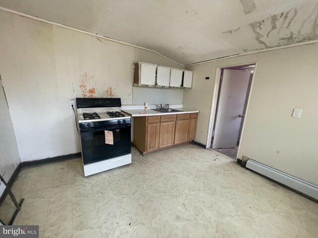 27 Church St, Bridgeton, NJ 08302 - kitchen featuring gas range oven, a sink, light flooring, lofted ceiling, and light countertops