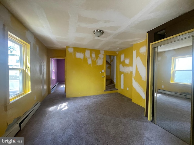 27 Church St, Bridgeton, NJ 08302 - unfurnished room with baseboard heating, carpet floors, a baseboard heating unit, and stairs