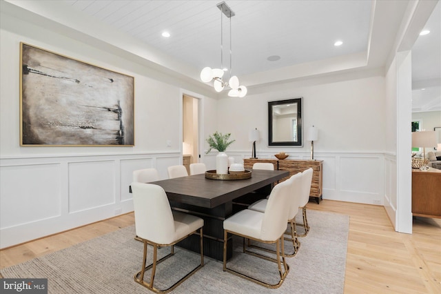 6613 Byrnes Dr, Mclean, VA 22101 - dining space featuring a decorative wall, light wood-style floors, a tray ceiling, wainscoting, and recessed lighting