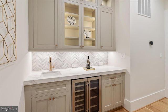 6613 Byrnes Dr, Mclean, VA 22101 - indoor wet bar with beverage cooler, tasteful backsplash, light wood-type flooring, and baseboards