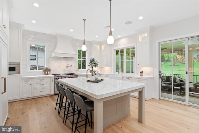 6613 Byrnes Dr, Mclean, VA 22101 - kitchen with premium range hood, double oven range, a sink, tasteful backsplash, and a breakfast bar