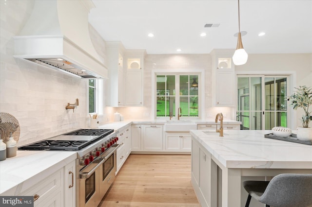 6613 Byrnes Dr, Mclean, VA 22101 - kitchen featuring custom exhaust hood, double oven range, light stone counters, white cabinetry, and recessed lighting