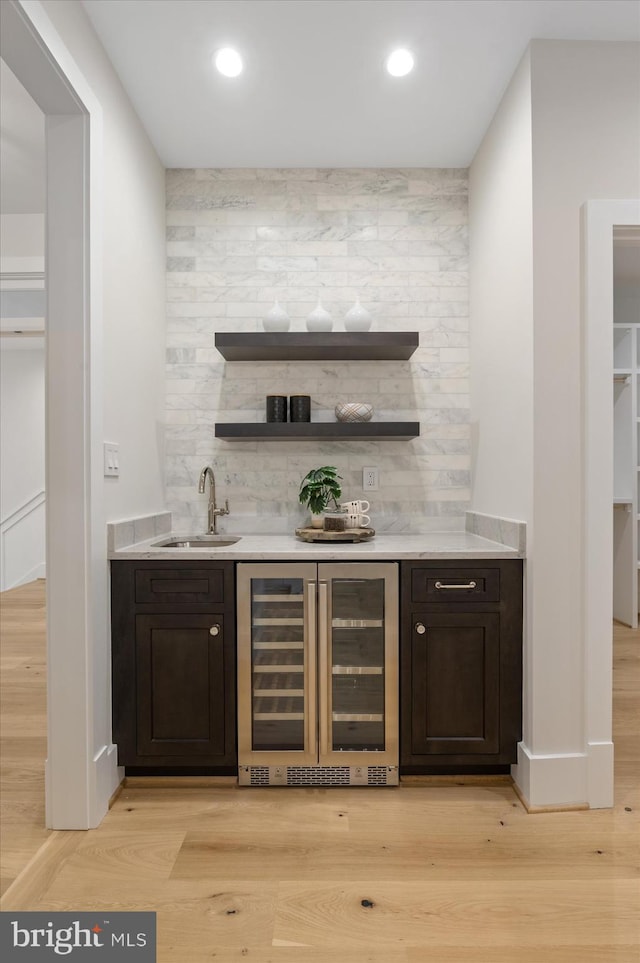 6613 Byrnes Dr, Mclean, VA 22101 - indoor wet bar with beverage cooler, light wood-type flooring, tasteful backsplash, recessed lighting, and baseboards