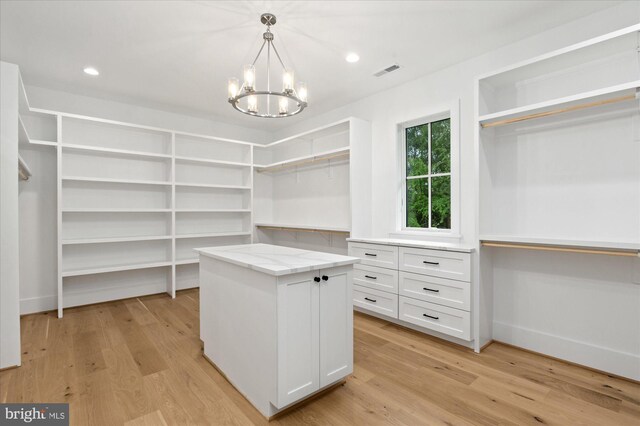 6613 Byrnes Dr, Mclean, VA 22101 - spacious closet with a chandelier and light wood finished floors