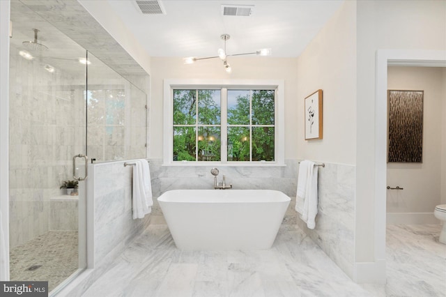 6613 Byrnes Dr, Mclean, VA 22101 - bathroom with a stall shower, marble finish floors, a soaking tub, toilet, and tile walls