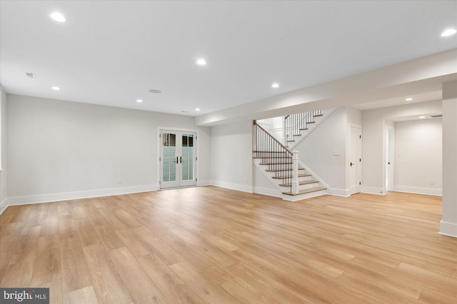 6613 Byrnes Dr, Mclean, VA 22101 - unfurnished living room with stairs, light wood finished floors, baseboards, recessed lighting, and french doors