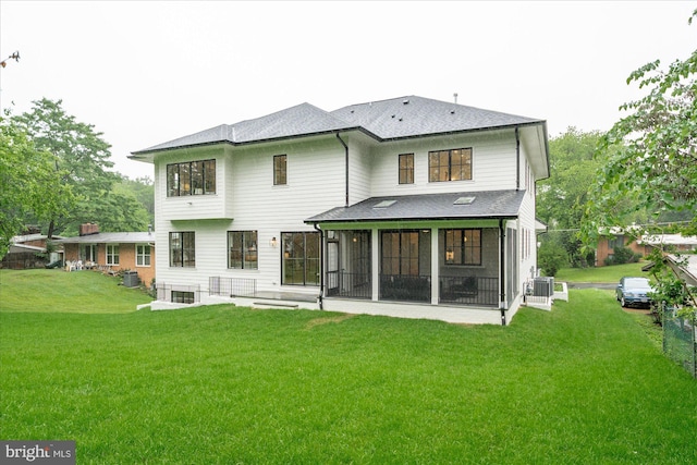 6613 Byrnes Dr, Mclean, VA 22101 - back of property with central AC, a sunroom, a lawn, and a shingled roof