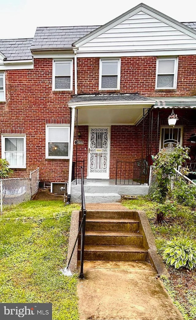 3925 Colborne Rd, Baltimore, MD 21229 - view of front facade with brick siding and a front yard
