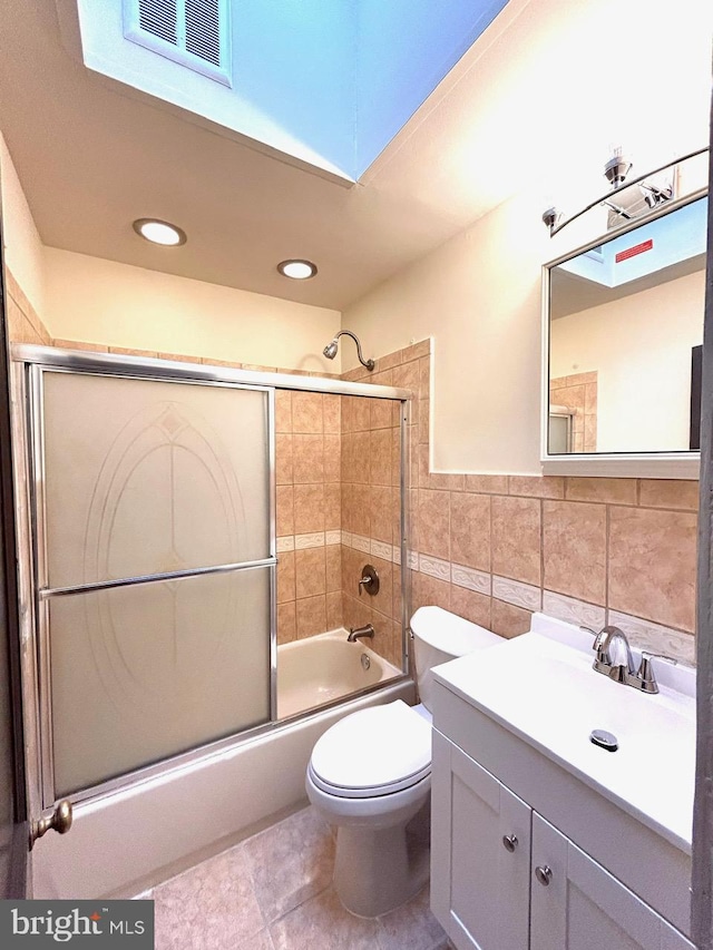 3925 Colborne Rd, Baltimore, MD 21229 - full bath featuring vanity, enclosed tub / shower combo, tile walls, toilet, and recessed lighting