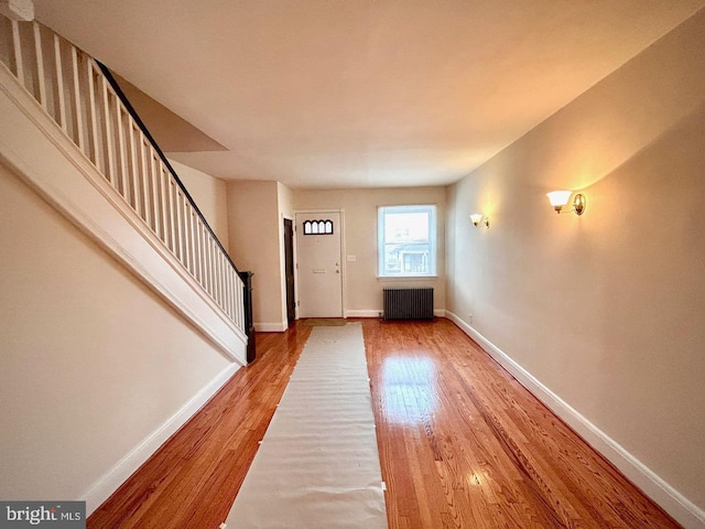 3925 Colborne Rd, Baltimore, MD 21229 - entrance foyer featuring radiator heating unit, wood finished floors, stairs, and baseboards