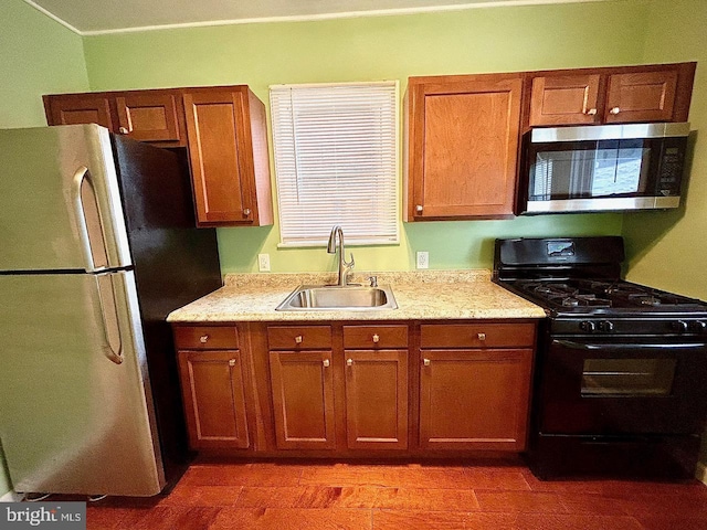 3925 Colborne Rd, Baltimore, MD 21229 - kitchen with appliances with stainless steel finishes, a sink, and brown cabinets