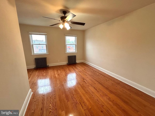 3925 Colborne Rd, Baltimore, MD 21229 - empty room with radiator, wood finished floors, a ceiling fan, and baseboards
