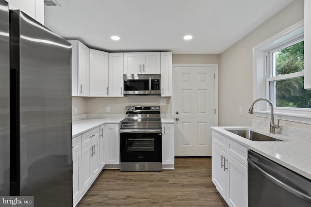 5210 57th Ave, Hyattsville, MD 20781 - kitchen featuring appliances with stainless steel finishes, a sink, white cabinets, and recessed lighting