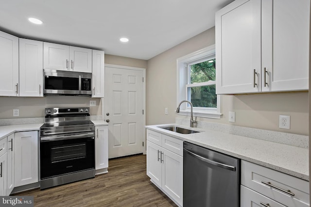 5210 57th Ave, Hyattsville, MD 20781 - kitchen with appliances with stainless steel finishes, a sink, white cabinets, light stone countertops, and recessed lighting
