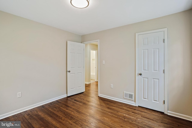 5210 57th Ave, Hyattsville, MD 20781 - unfurnished bedroom featuring dark wood finished floors and baseboards
