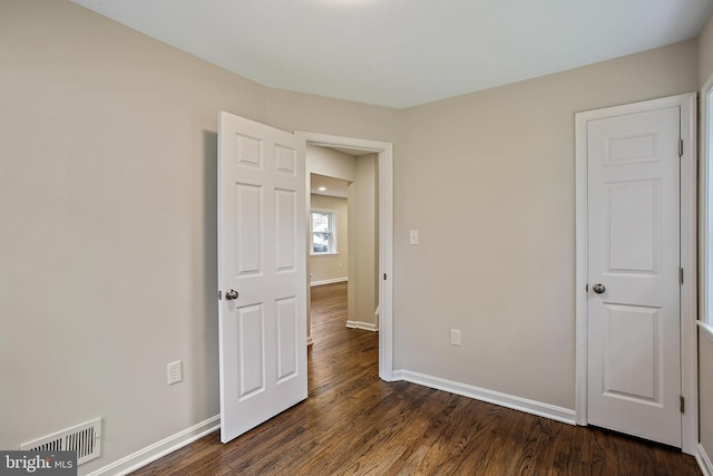 5210 57th Ave, Hyattsville, MD 20781 - unfurnished bedroom featuring dark wood-style floors and baseboards