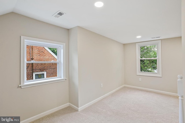 5210 57th Ave, Hyattsville, MD 20781 - empty room with plenty of natural light, carpet floors, baseboards, recessed lighting, and lofted ceiling